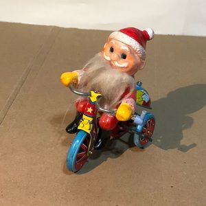 Vintage tin wind-up toy Santa riding a trike